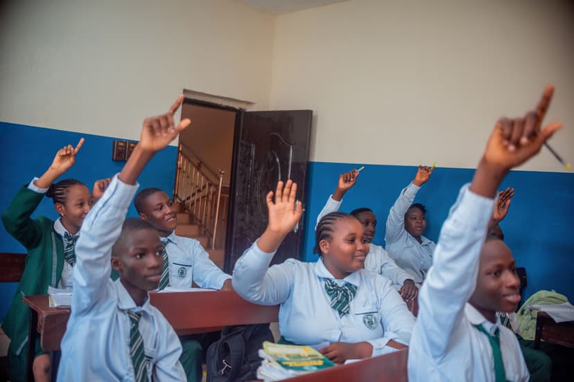 Group of students raising hands