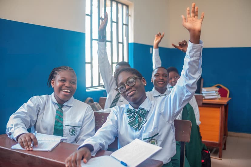 Students enthusiastically raising hands
